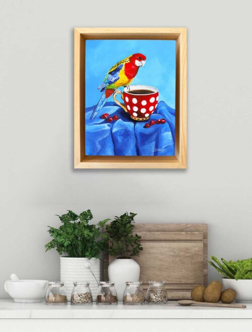 "Rosella's Roast" an original acrylic painting of an Eastern Rosella perched on a polka-dot teacup, from Jess King's Found and Collected series.